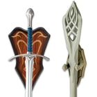Close up image of the Glamdring Sword and the Staff of Gandalf the White hanging on the included wall plaque.
