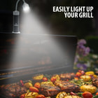 Full image of Grilling Lights magnetically attached to a grill with the light on.