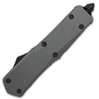 The grey handle is made of high-quality metal alloy with the deployment button placed along the spine for fast opening