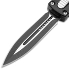 Detailed view of the dagger style stainless steel blade with black coating.