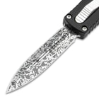 Detailed view of the dagger style Damascus blade with unique pattern.