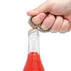 Full image of the Knuckle Bottle Popper popping a bottle cap off a bottle.