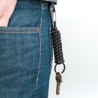 Full image of the Black Paracord Keychain with Carabiner clipped onto jeans.