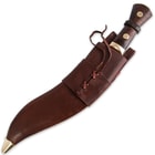 The knife is housed in a leather scabbard and also houses two additional 4” tools: a small cutting knife and miniature sharpening steel.