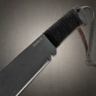 Rambo 4 Gil Hibben IV Machete Knife Man Holding a Machete style Knife with a rugged, dark blade. Displaying a machete sheath on other hand