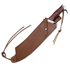 Machete knife housed in a brown leather sheath with strap.