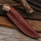 The fixed blade in its leather sheath