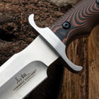 A close-up of the fixed blade's handguard and handle