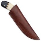 The 7 3/4” overall fixed blade knife can be carried and stored in a premium leather belt sheath