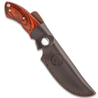 The 9” knife housed in a brown leather sheath with Timber Wolf logo embossed on the side.