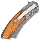 On the back of the wooden handle scales is a stainless steel pocket clip for easy carrying.