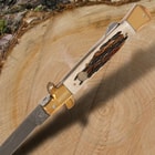 The knife’s burnt bone handle is accented by brass-plated nickel silver pins and bolsters.