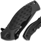 Detailed view the ergonomic, no-slip rubberized polymer handle with pocket clip.