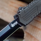 “Viper” is printed on the black stainless steel blade of the knife where it extends from the aluminum handle.