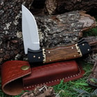 The pocket knife halfway open with its sheath