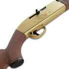 A side angle image of the Crosman 1000 100 year anniversary centenial edition which features gold accents. This view shows the trigger assembly and the receiver.