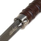 Close up image of the button that pushes the blade out on the Damascus Gentleman's Hook Sword Cane.
