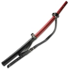 The 39 1/2” overall katana’s wooden handle is intricately wrapped in eye-catching, red faux leather and black rayskin
