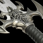Detailed view of the bat wing style guard with leather wrapped handle accented with rune-like characters. 