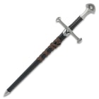 Full zoomed out view of middle ages warrior short broadsword in black sheath wrapped with brown leather belt
