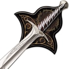 Zoomed view of Sting sword of Frodo with runes on the silver blade and handguard displayed on top of wooden plaque
