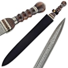 Gladiator sword secured in black leather sheath with detailed view of heartwood handle and Damascus steel blade. 