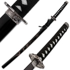 The katana is shown inside the scabbard with dragon design and with zoomed views of the hibaki and cast steel tsuba. 