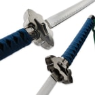 The cloud shaped guard is shown from two views with angled shots of the blue cord wrapped handle and carbon steel blade. 