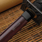 A black katana encased in a black scabbard with a handle wrapped in faux ray skin

