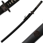 The habaki has a wave-like pattern while the scabbard has a floral design that matches the tsuba. 