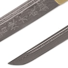 The Damascus steel blade has symbols down it with dual blood grooves, and razor sharp point. 