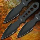 The three black throwing knives have weight balancing holes on the handles.