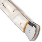 The 7 1/4” closed pocket knife has faux pearl handle scales, and the push button and slide lock are conveniently on top