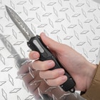 The double action OTF knife shown in hand
