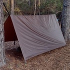 The tarp shown pitched between two trees