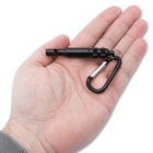 Full image of the Whistle and Carabiner being held in hand.