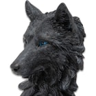 This iamge shows the intricate details of the the fur and whiskers on the face of this black wolf desk clock.