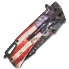 closed patrotic pocket knife with black pocket clip and glass breaking pommel along with and distressed American flag handle and "Join, or die" inscription on the blade.
