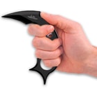 A hand is shown holding the stainless steel claw by its thumb grip.