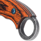 It has a full-tang, 5 1/2” 3Cr13 stainless steel blade with a non-reflective finish and finger ring holes and an open-ring pommel