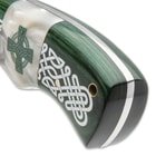 The Kelly green wooden handle scales are secured to the full-tang blade with brass pins and the handle has a lanyard hole