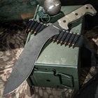 The 17” machete with stonewashed blade and tan G10 handle is shown on a tactical background.