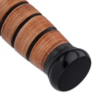 It has the classic stacked, genuine leather handle, recognizable the world over, and a black, non-reflective pommel