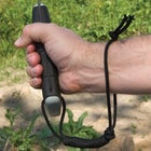 The machete has a lanyard hole and is shown with a lanyard wrapped around a wrist.