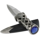 This knife has a faux blue jewel pommel on its twisted handle and comes with a black sheath with metal tip.