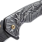 Side view of the knife’s cast stainless steel handle with engraved Shogun artwork.