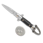The Black Fratellino Keychain Stiletto is shown open with 1” blade and black handle next to a quarter.