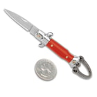 The Red Fratellino Keychain Stiletto is shown open with 1” blade and black handle next to a quarter.
