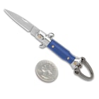 The Blue Fratellino Keychain Stiletto is shown open with 1” blade and black handle next to a quarter.