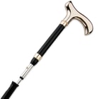 Zoomed view of the gold and black handle with button that releases the blade from the cane shaft. 